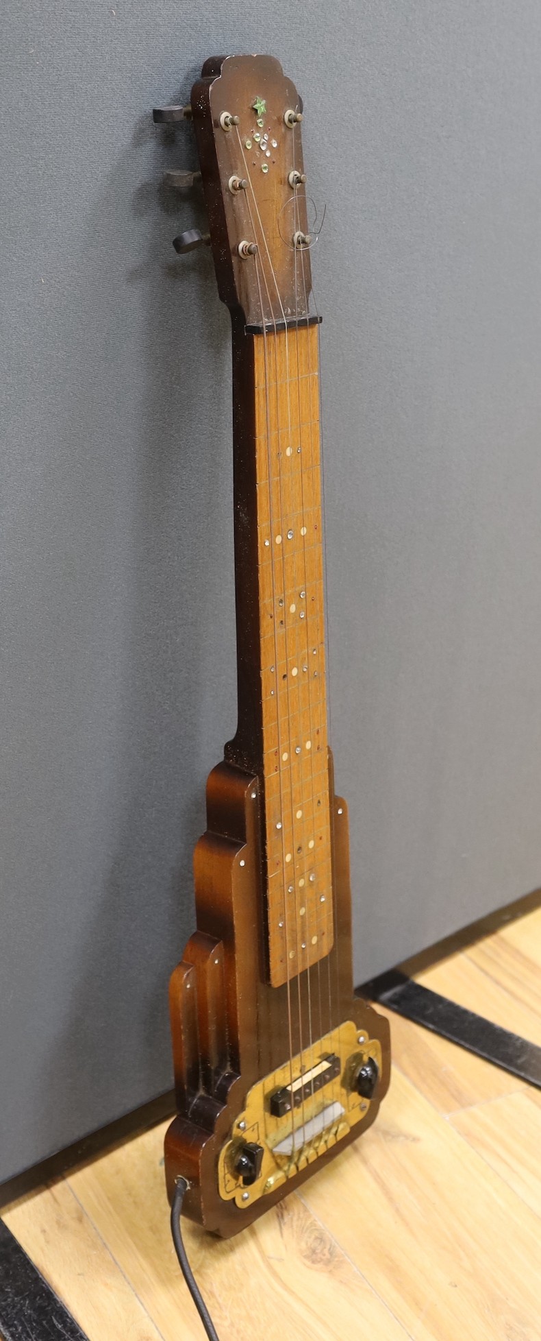 A steel guitar, the case, inscribed Haiwaians, 83cms high